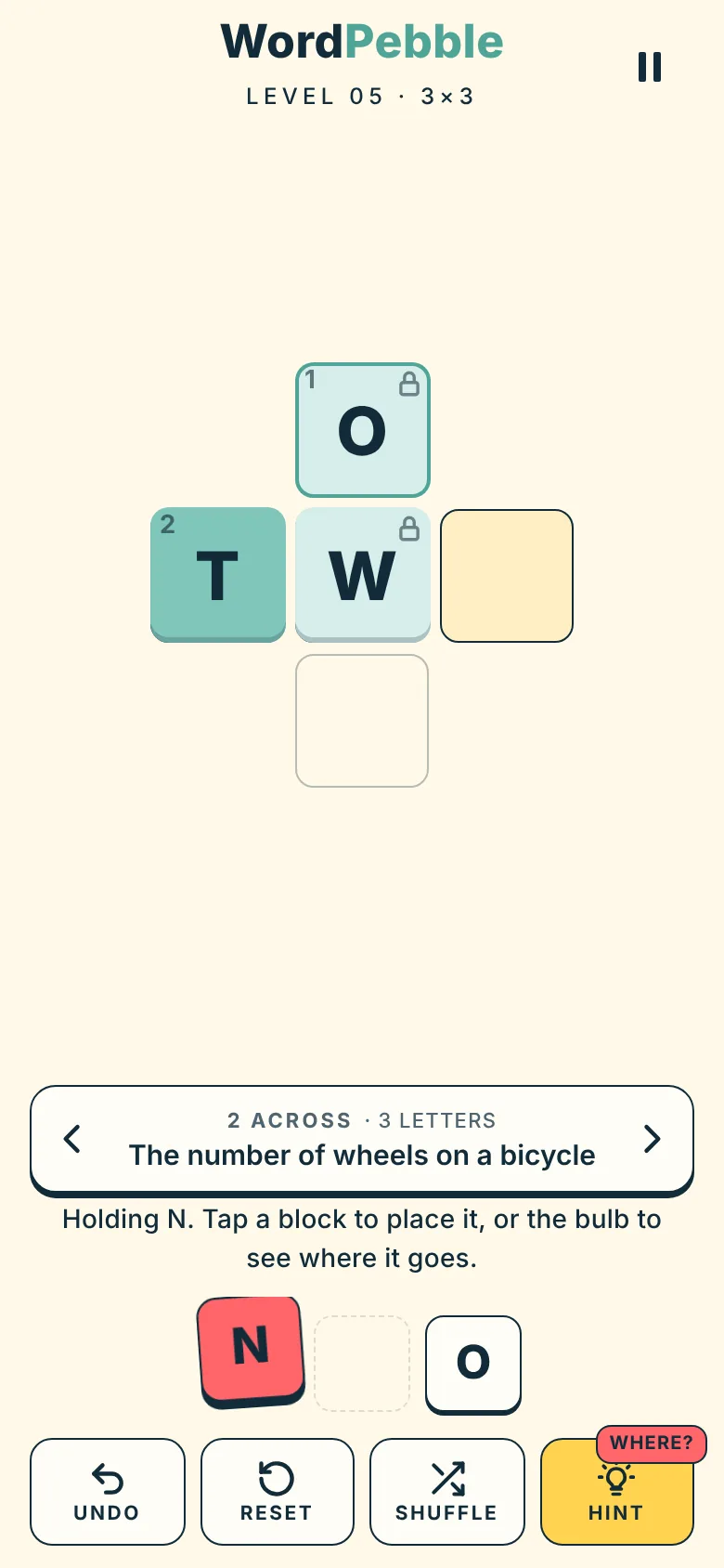 A letter N picked up from the tray, with one letter already placed on the board.
